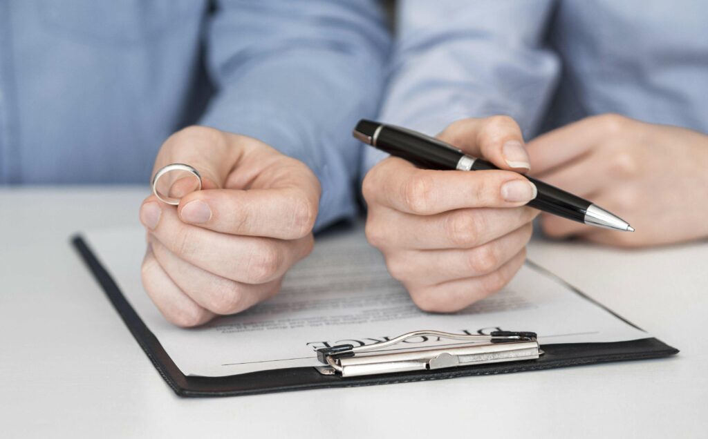 Close Up Couple Signing Divorce Contract