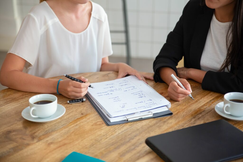 徵信公司服務項目 5 Young Female Colleagues Meeting Discussing Business Plan Writing Strategy Scheme Paper Making Draft